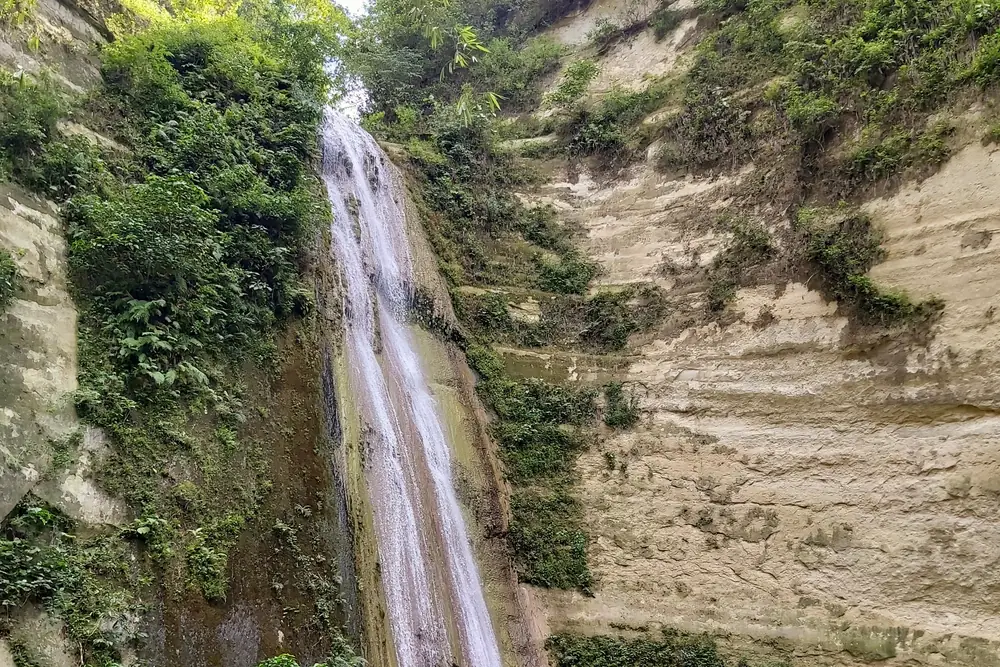 Dao Falls cascading down a limestone cliff into a pool in Samboan, southern Cebu