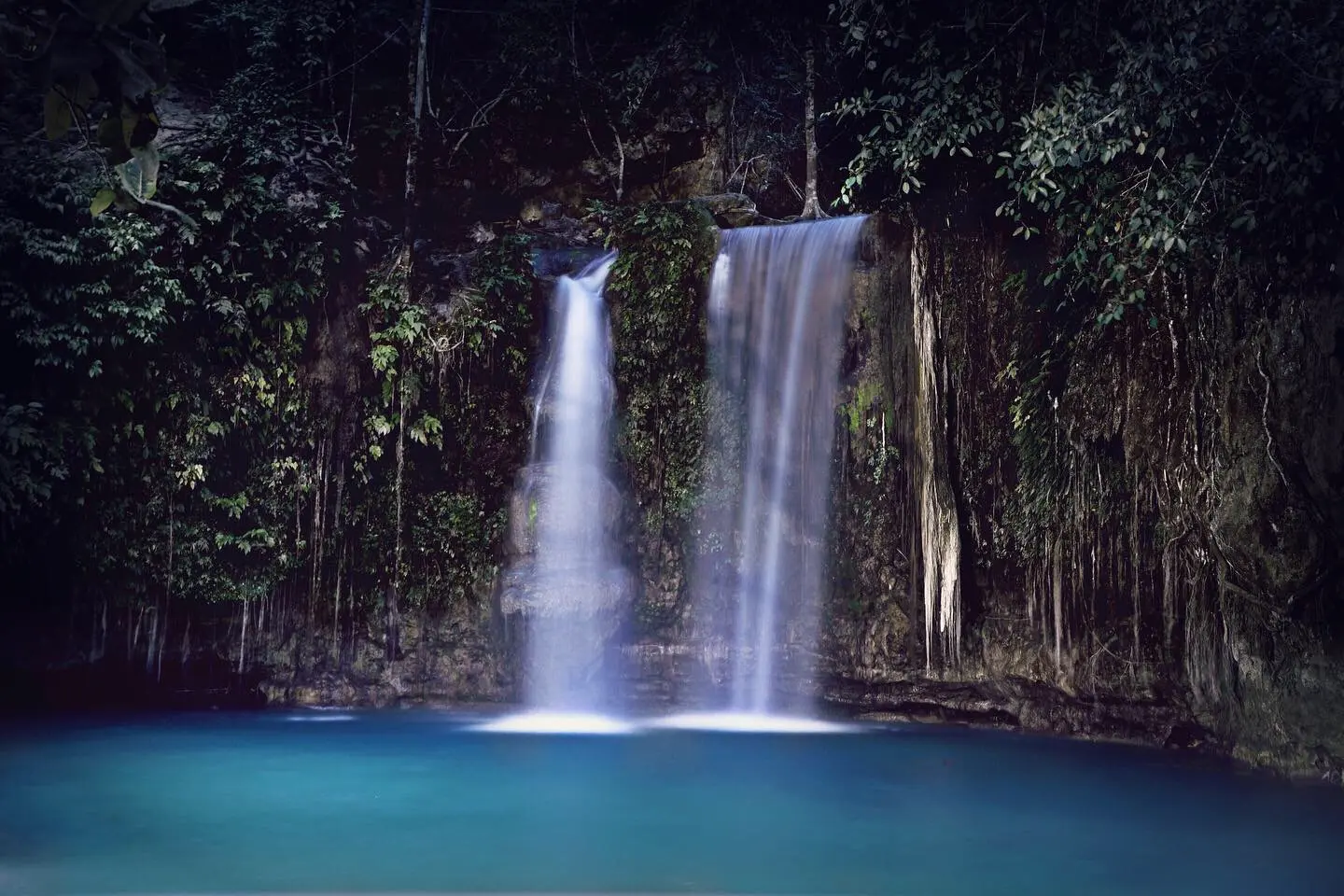 A canyoneering jump spot above bright turquoise water on the Kanlaob route to Kawasan Falls in Badian, Cebu