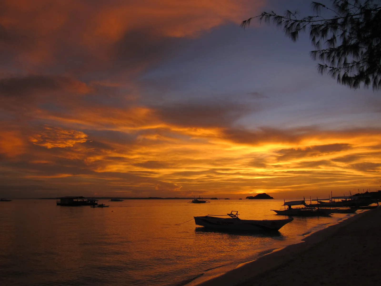 Photo: Htkava / CC BY-SA 3.0, via Wikimedia Commons Sunset over the calm water off Bounty Beach, Malapascua Island, Cebu