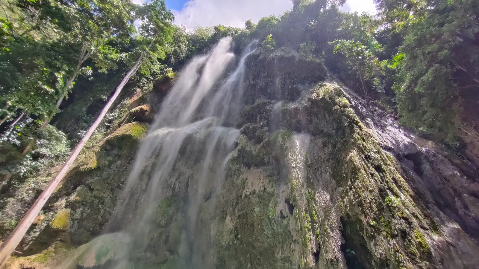 Water sheeting over the wide, mossy tiers of Tumalog Falls near Oslob, Cebu