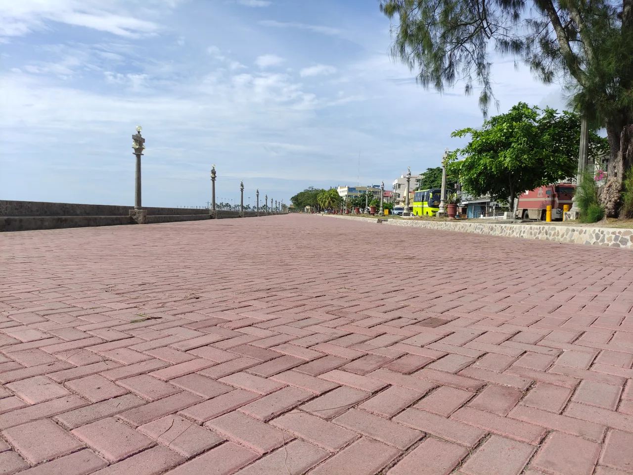 Photo: Marion Paul Baylado / CC BY-SA 3.0, via Wikimedia Commons The broad brick-paved waterfront promenade on Rizal Boulevard in Dumaguete City under a blue sky