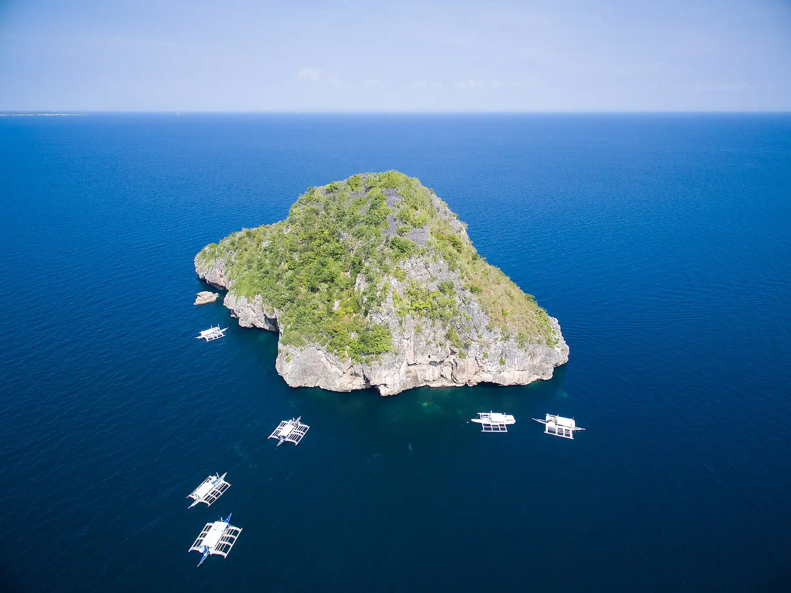 Aerial view of Gato Island with dive boats moored nearby