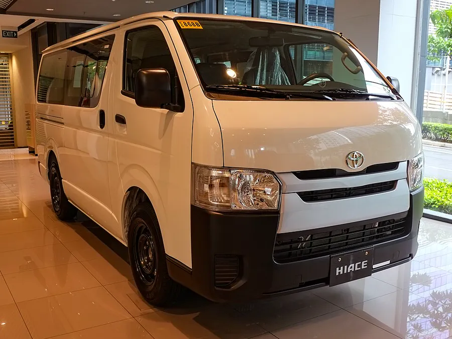 White Toyota HiAce Commuter passenger van, front three-quarter view